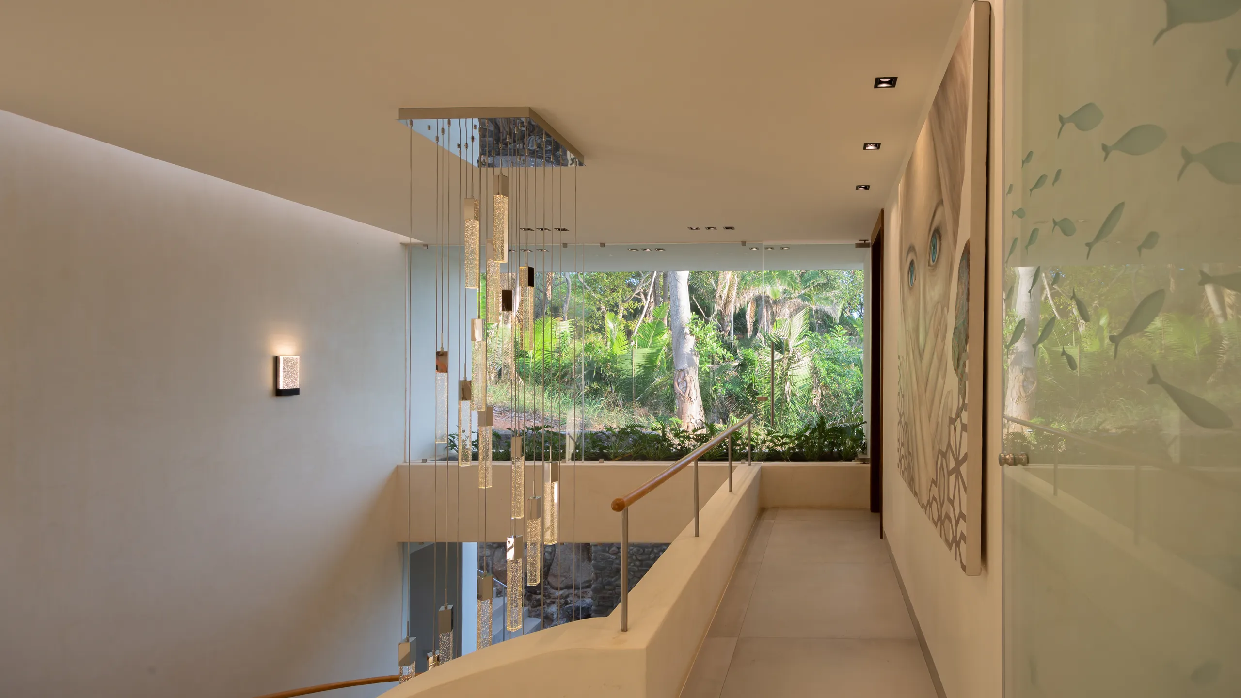 Clean architectural lines, custom lighting, and natural surroundings create a calm and sophisticated interior atmosphere.