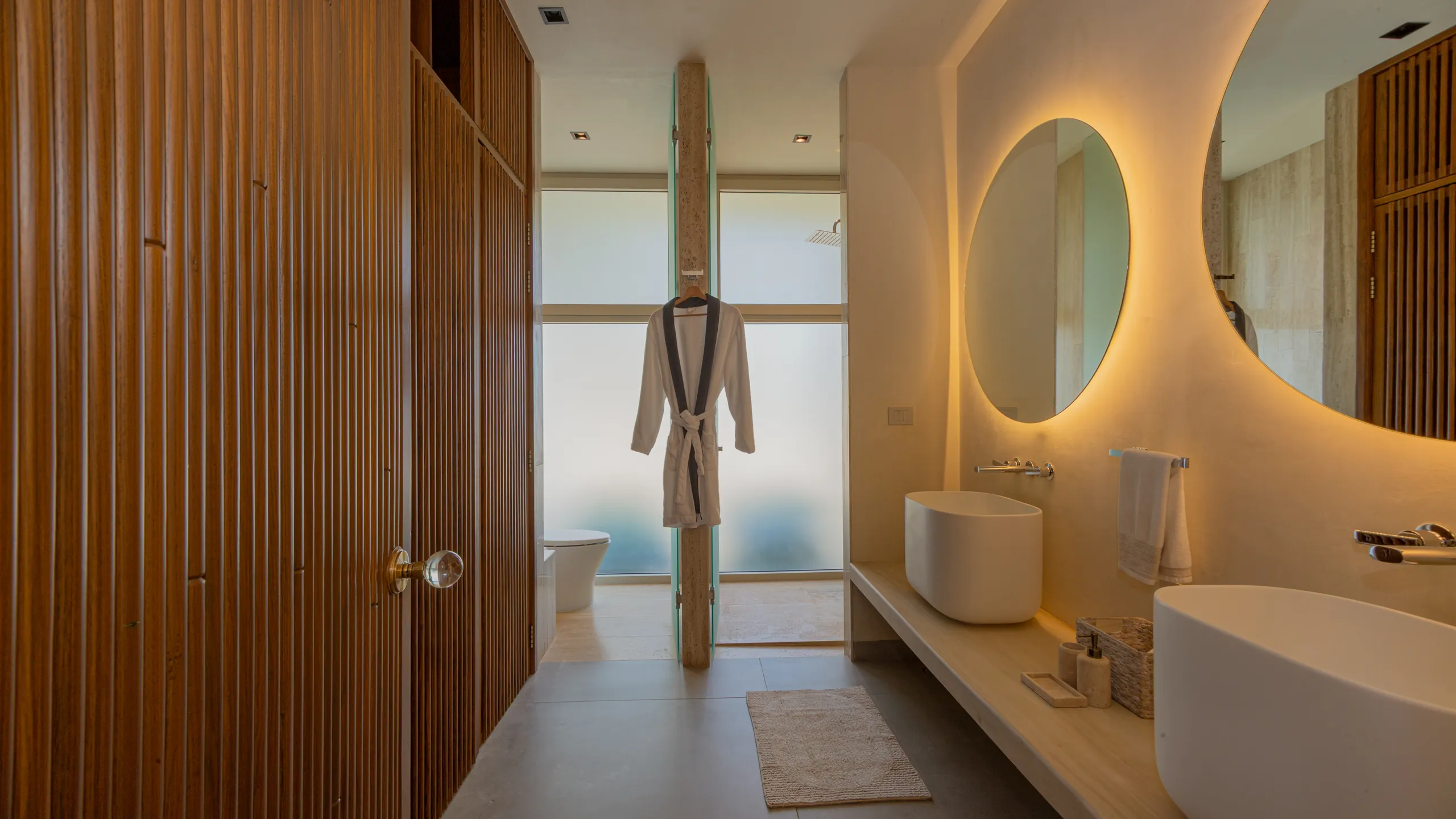 Spa-inspired bathroom featuring natural textures, warm lighting, and contemporary finishes throughout.