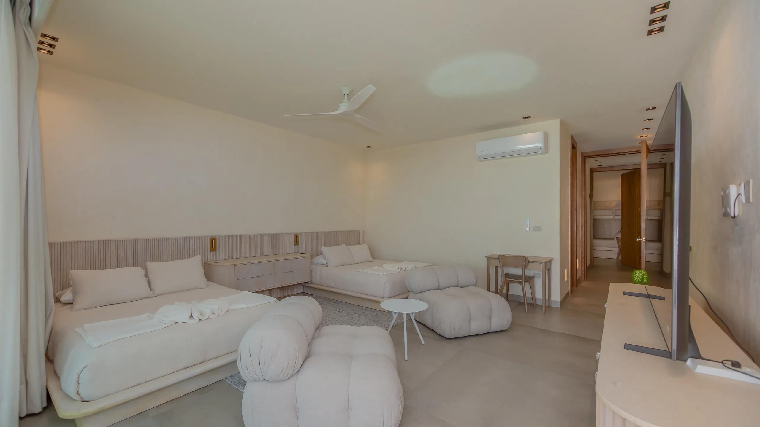 Expansive bedroom suite designed for comfort, flexibility, and relaxed coastal living.