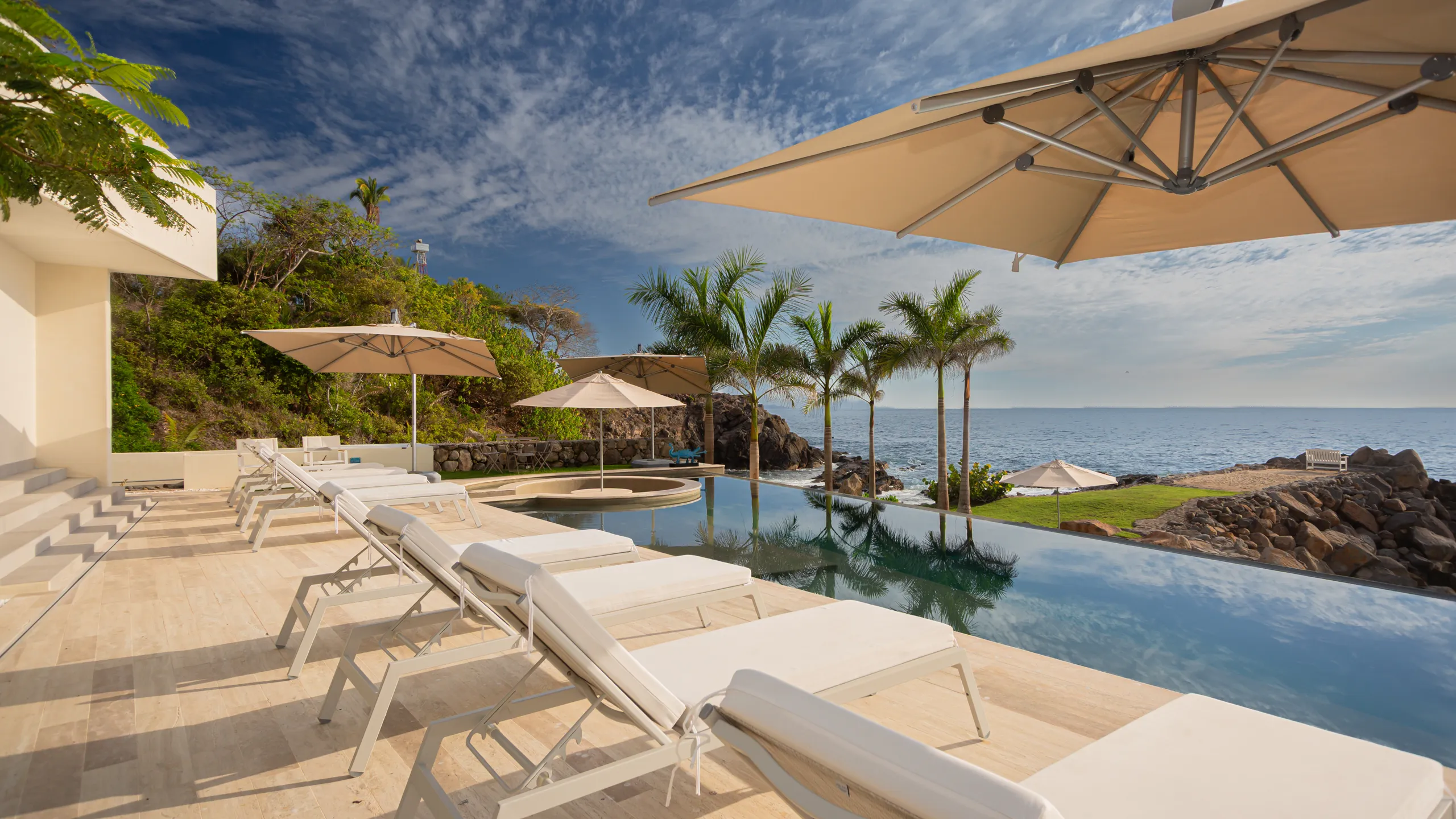 Resort-style pool terrace designed for relaxed coastal living, private gatherings, and sunset-facing ocean views.