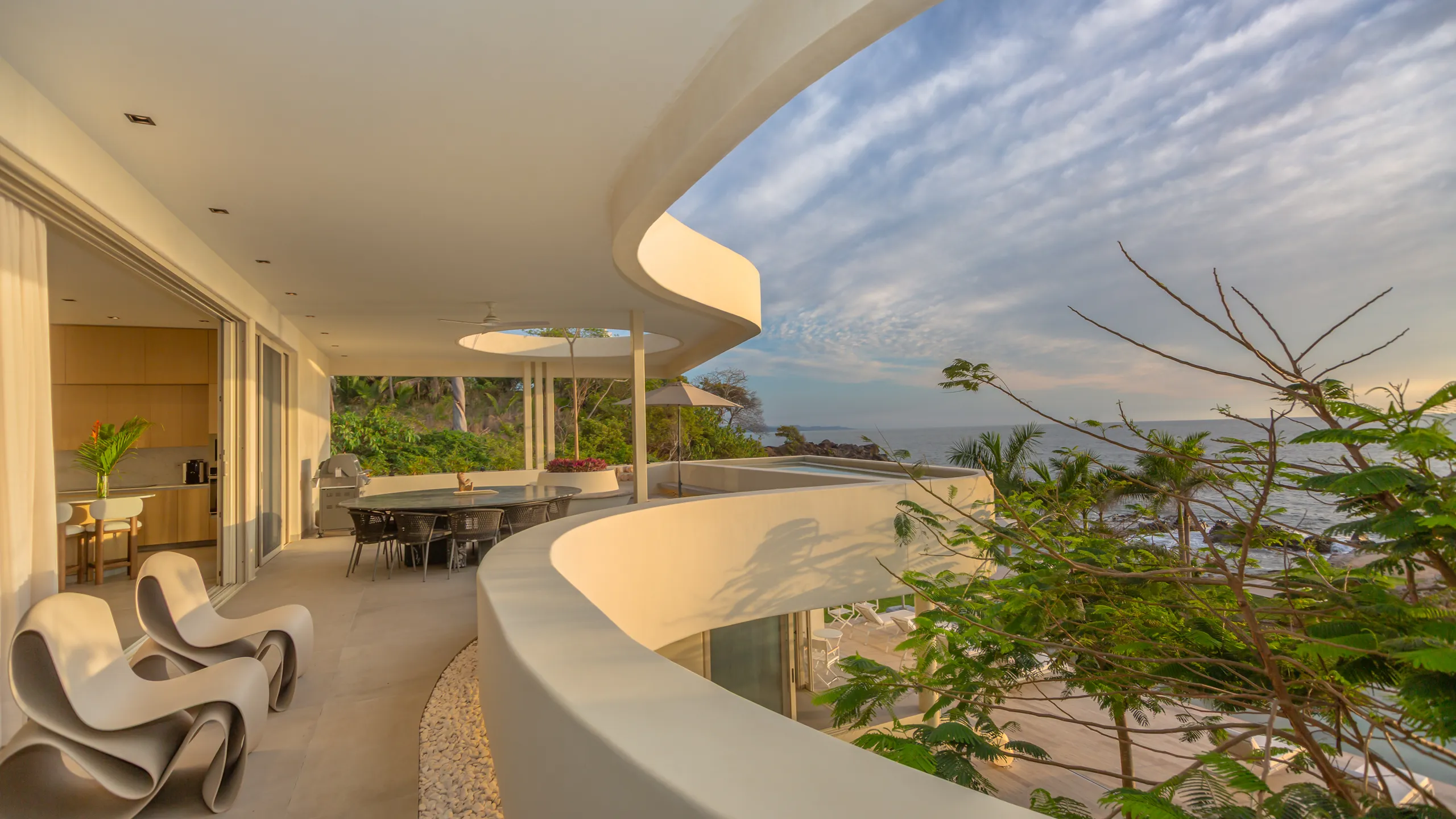 Curved architectural lines and open terraces frame panoramic views while enhancing airflow and natural light throughout the residence.