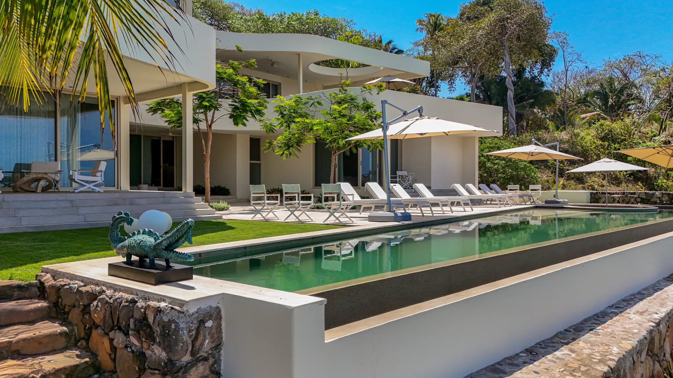 Minimalist exterior design combined with resort-inspired amenities creates a residence focused on privacy and coastal sophistication.